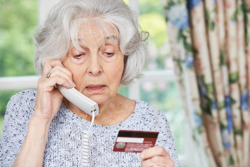 senior woman giving credit card over the phone