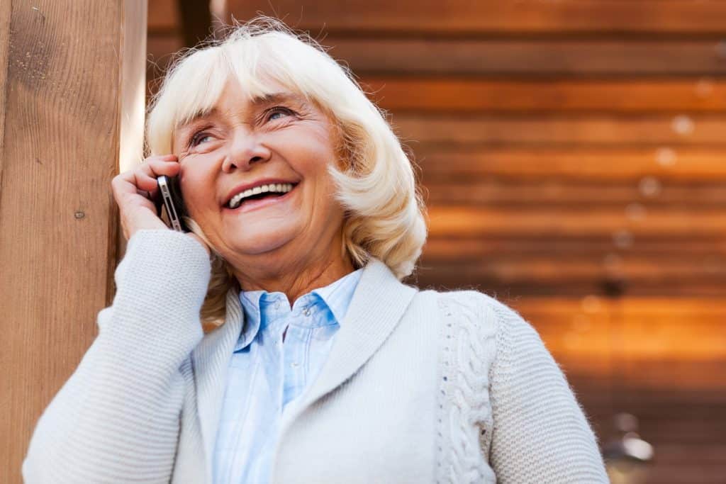 Senior woman smiling while talking on the phone