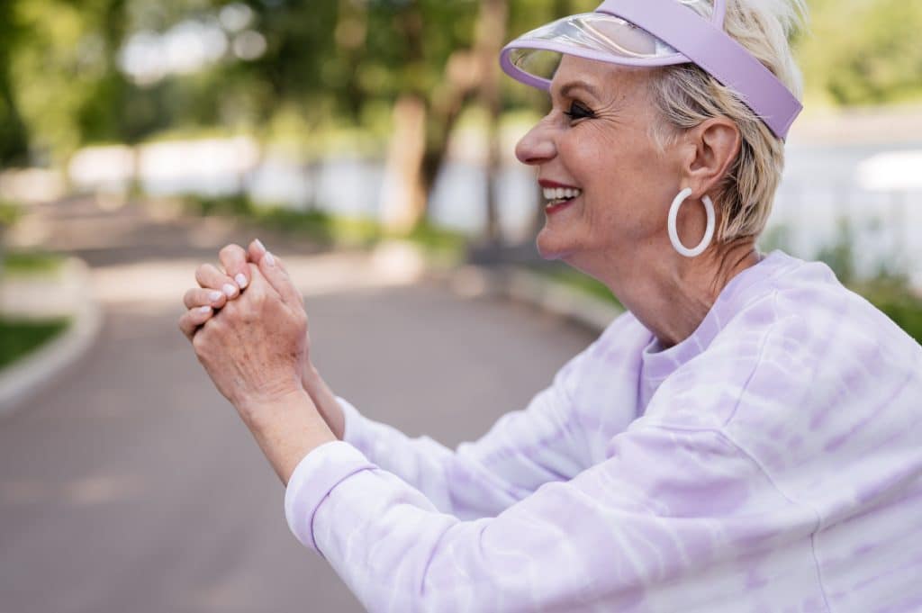 attractive senior woman laughing outside