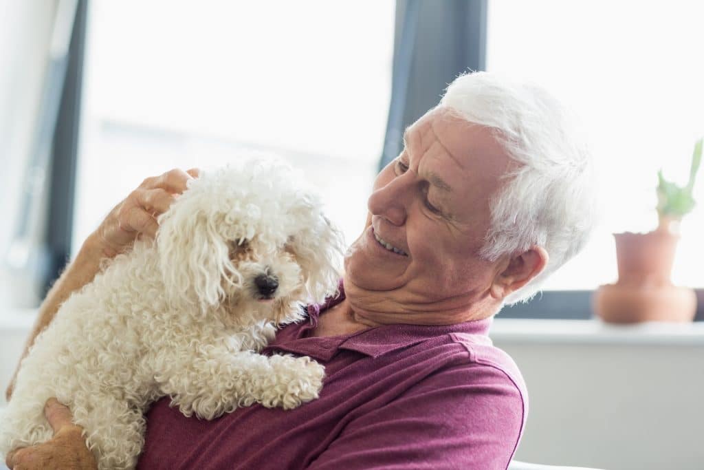 senior man holding a dog